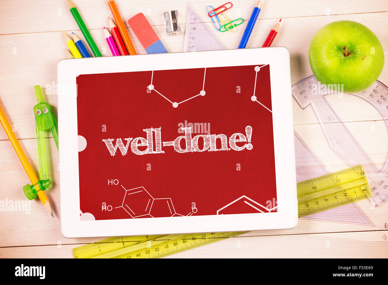 Well-done! against students desk with tablet pc Stock Photo