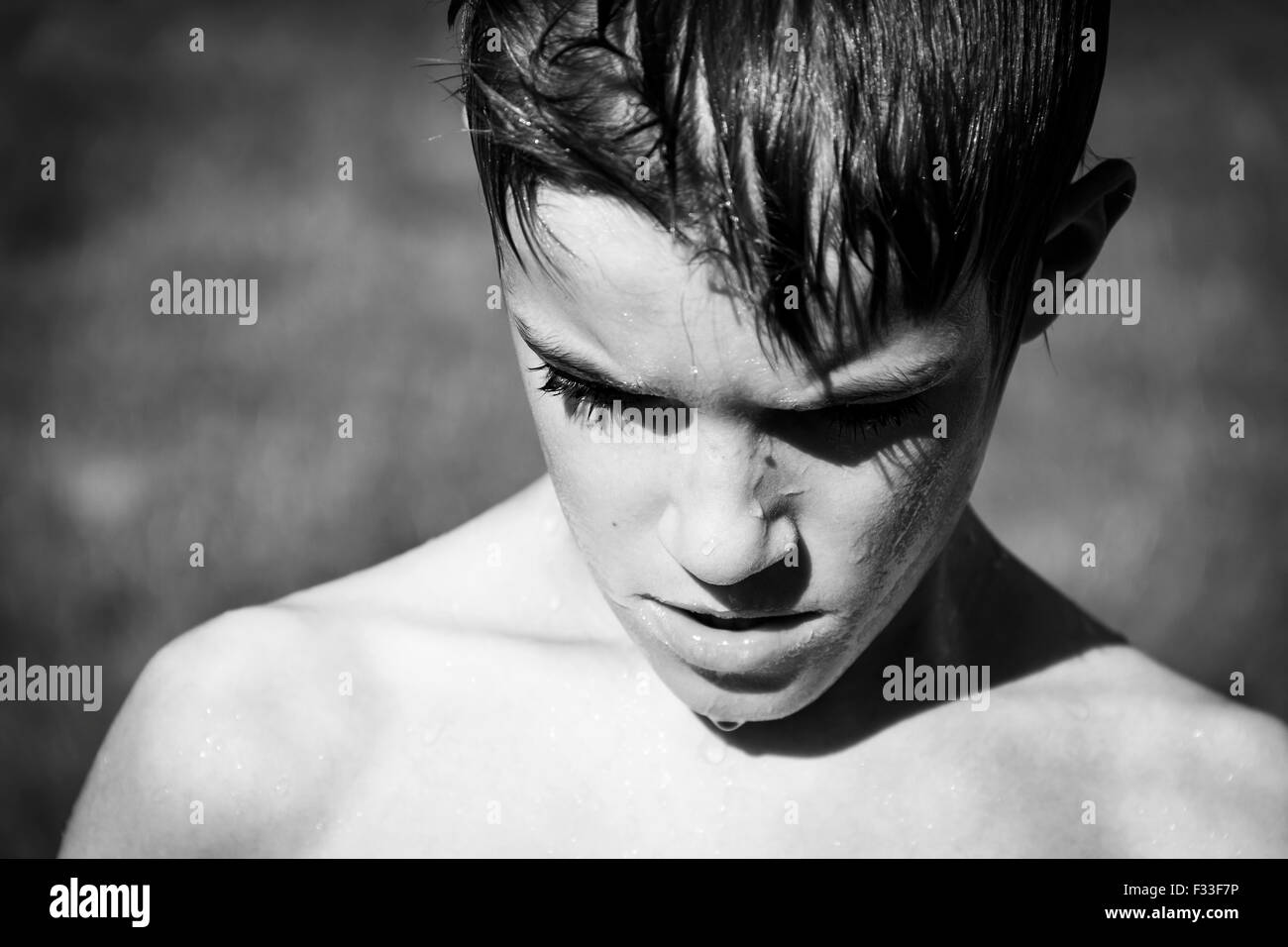 Young boy outdoors wet. Stock Photo