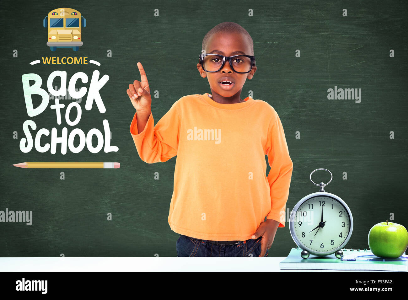 Composite image of cute boy smiling and pointing Stock Photo - Alamy