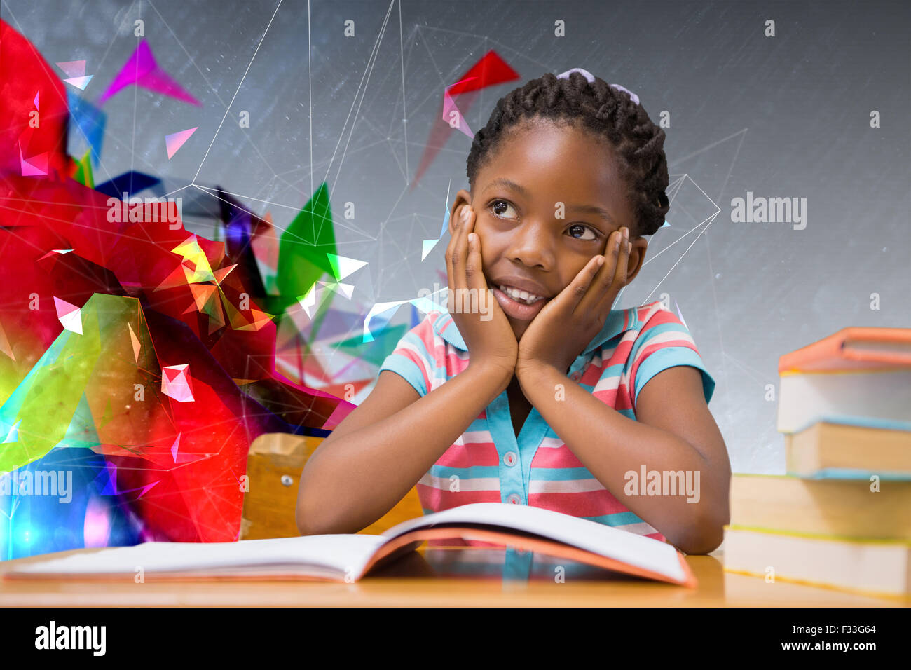 Composite image of pupil sitting at her desk Stock Photo - Alamy