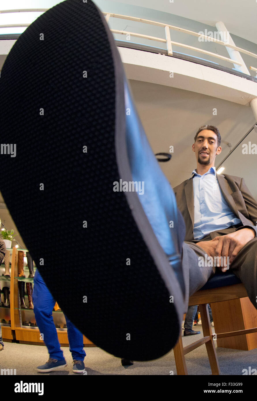Sultan Koesen, the world's tallest person at 2.51 metres, shows off his new shoes in Vreden, Germany, 29 September 2015. He wears custom-made size 60 footwear made by Wessels shoemakers, who cater specially for extra-large feet. PHOTO: FRISO GENTSCH/DPA Stock Photo