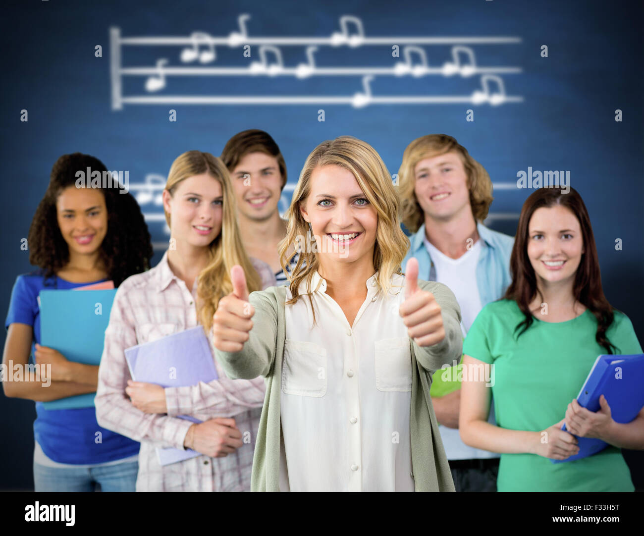 Composite image of college students gesturing thumbs up Stock Photo - Alamy