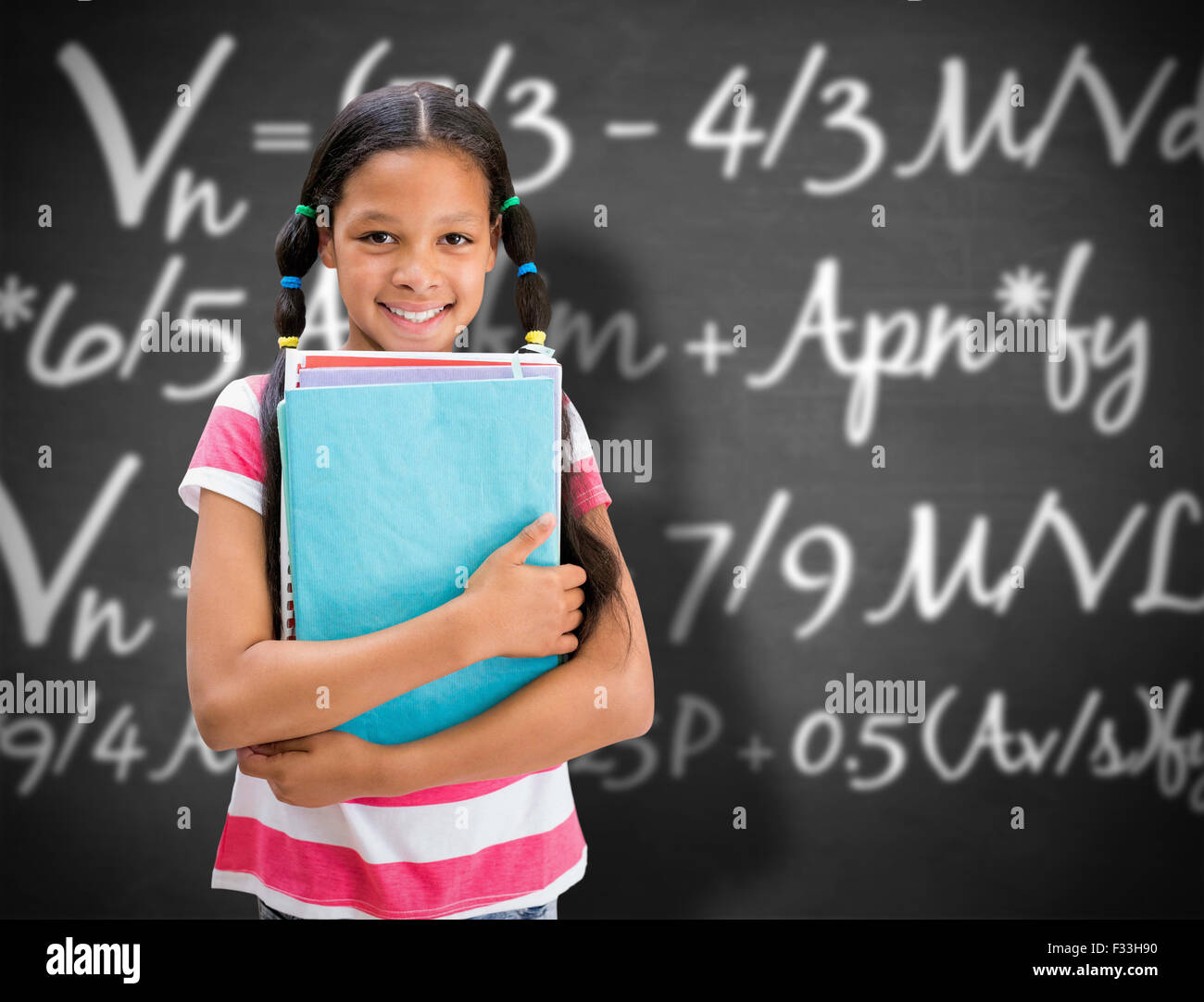 Composite image of cute pupil smiling at camera in library Stock Photo ...