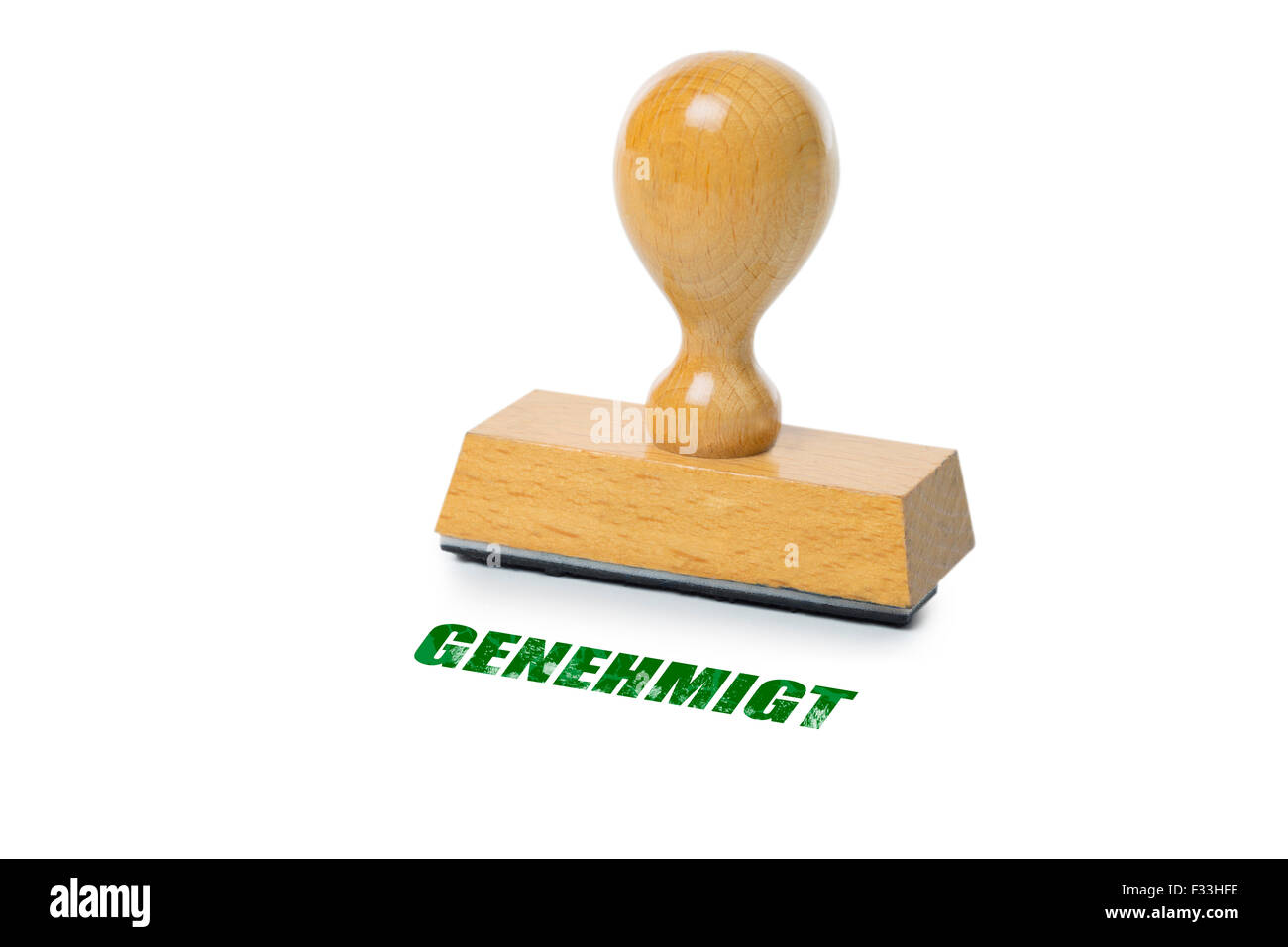 Genehmigt (German Approved) printed in red ink with wooden Rubber stamp isolated on white background Stock Photo