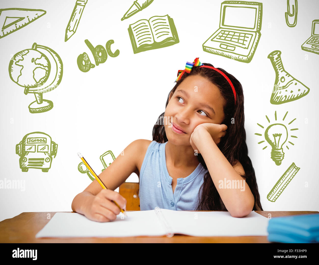 Composite image of cute pupil at desk Stock Photo - Alamy