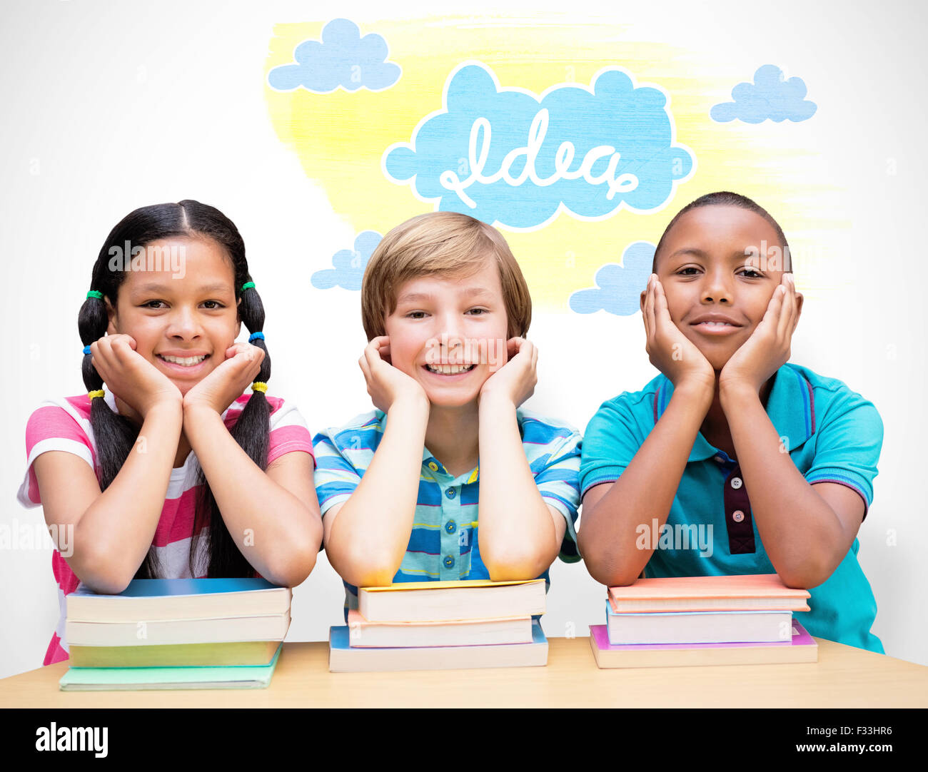 Composite image of cute pupils looking at camera in library Stock Photo ...