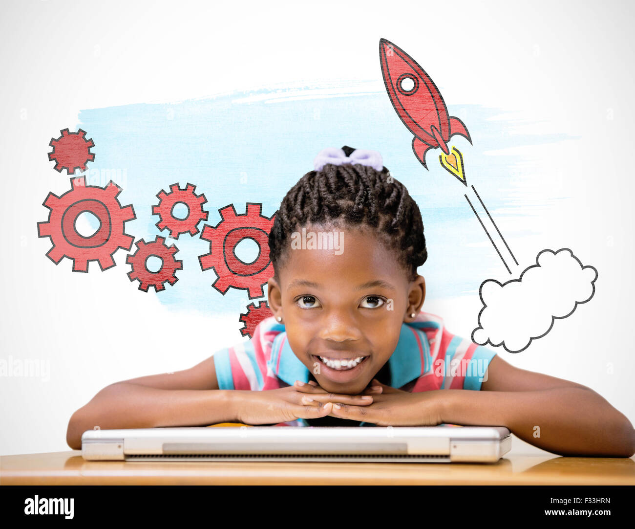 Composite image of smiling pupil sitting at her desk Stock Photo - Alamy