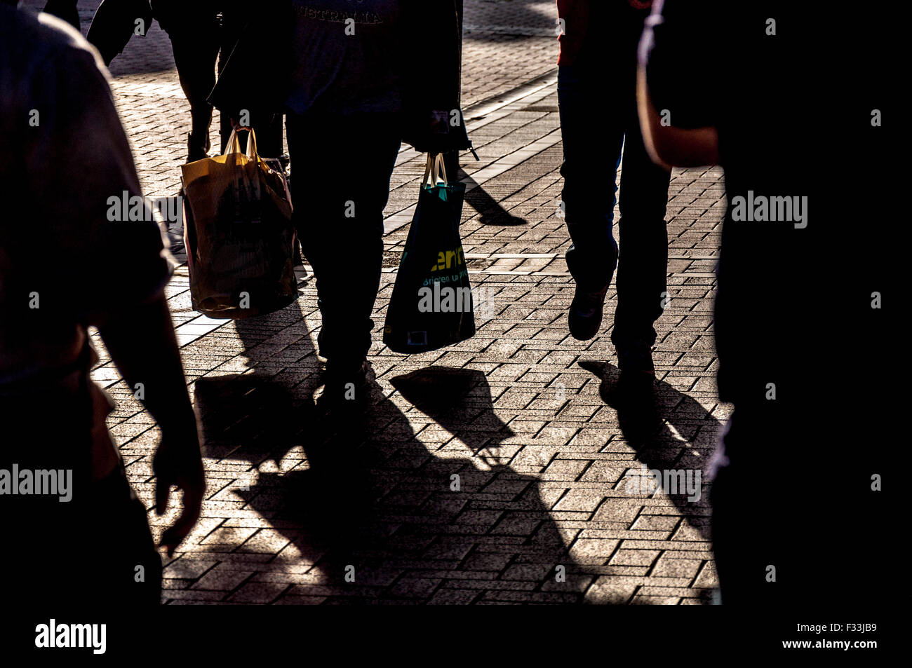 Pedestrians shoppers in Dublin, Ireland with plastic carrier shopping