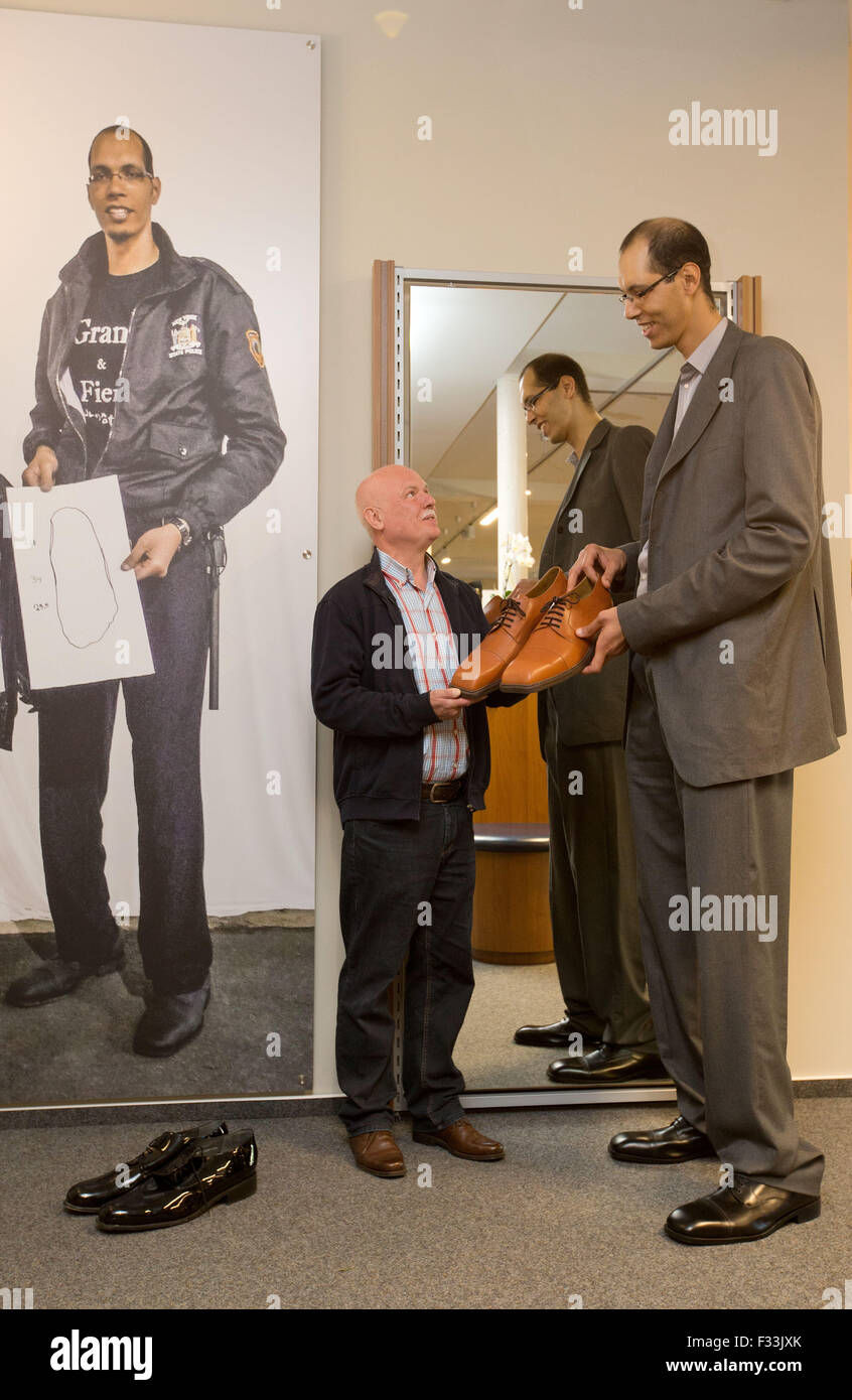 Vreden, Germany. 29th Sep, 2015. Brahim Takioullah (r), the world's second tallest person at 2.46 metres, gets size 60 shoes from shoemaker Georg Wessels in Vreden, Germany, 29 September 2015. Wessels shoemakers cater specially for extra-large feet. PHOTO: FRISO GENTSCH/DPA/Alamy Live News Stock Photo