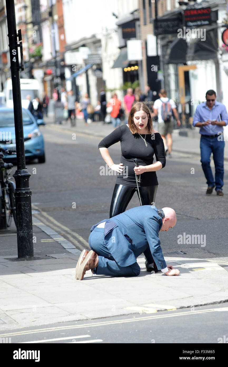 A Man Being Publicly Humiliated By A Dominatrix In The Streets Of Soho Where He Was Made To