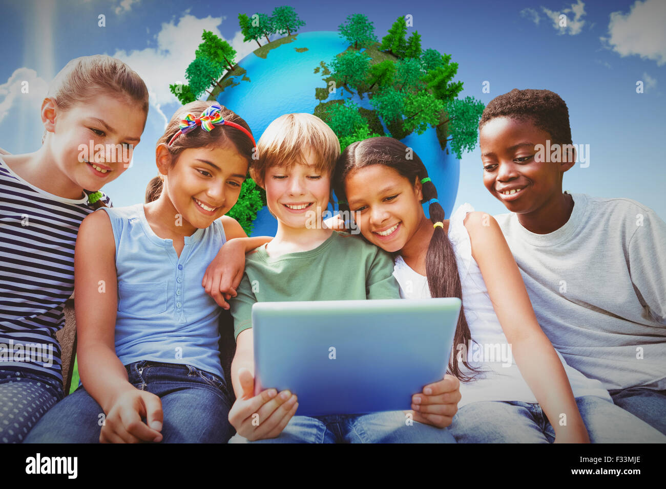Composite image of happy children using digital tablet at park Stock ...