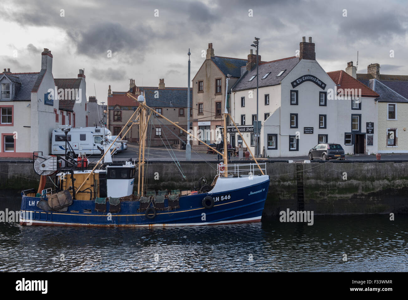 A Trawler at the quayside in Eyemouth Harbour Stock Photo
