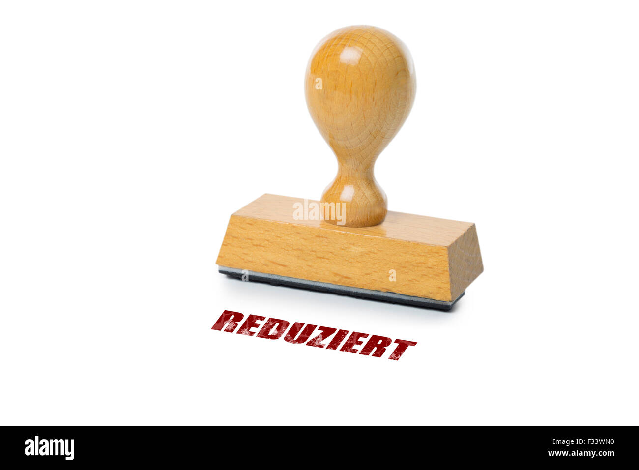 Reduziert (German Reduced) printed in red ink with wooden Rubber stamp isolated on white background Stock Photo