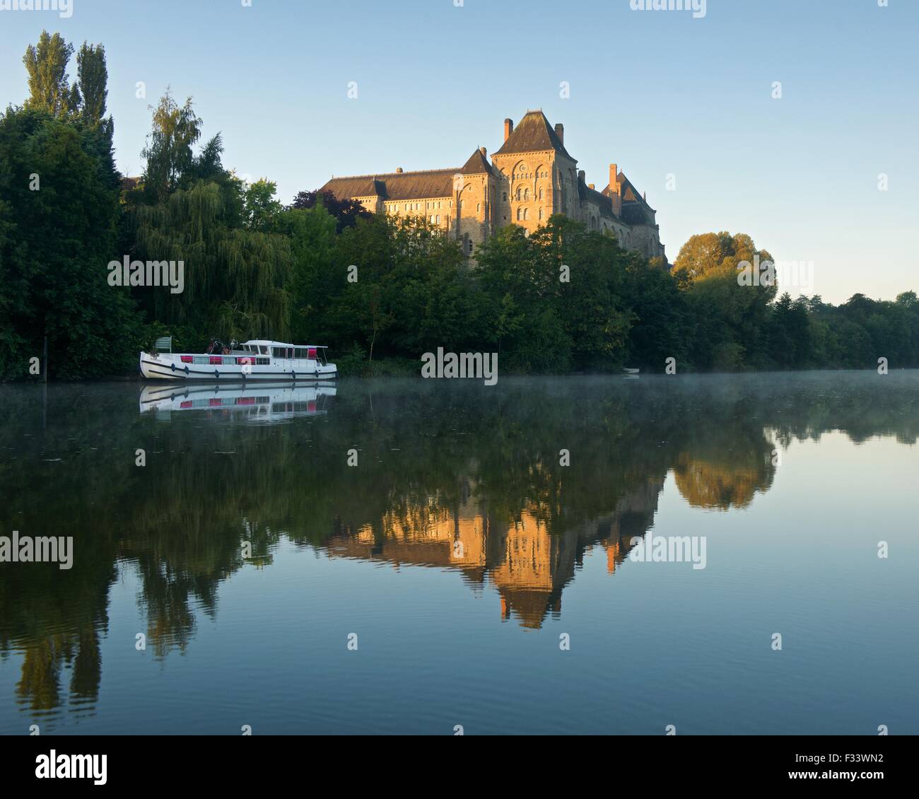 Solesmes abbey reflected into the river sarthe photographed on an still