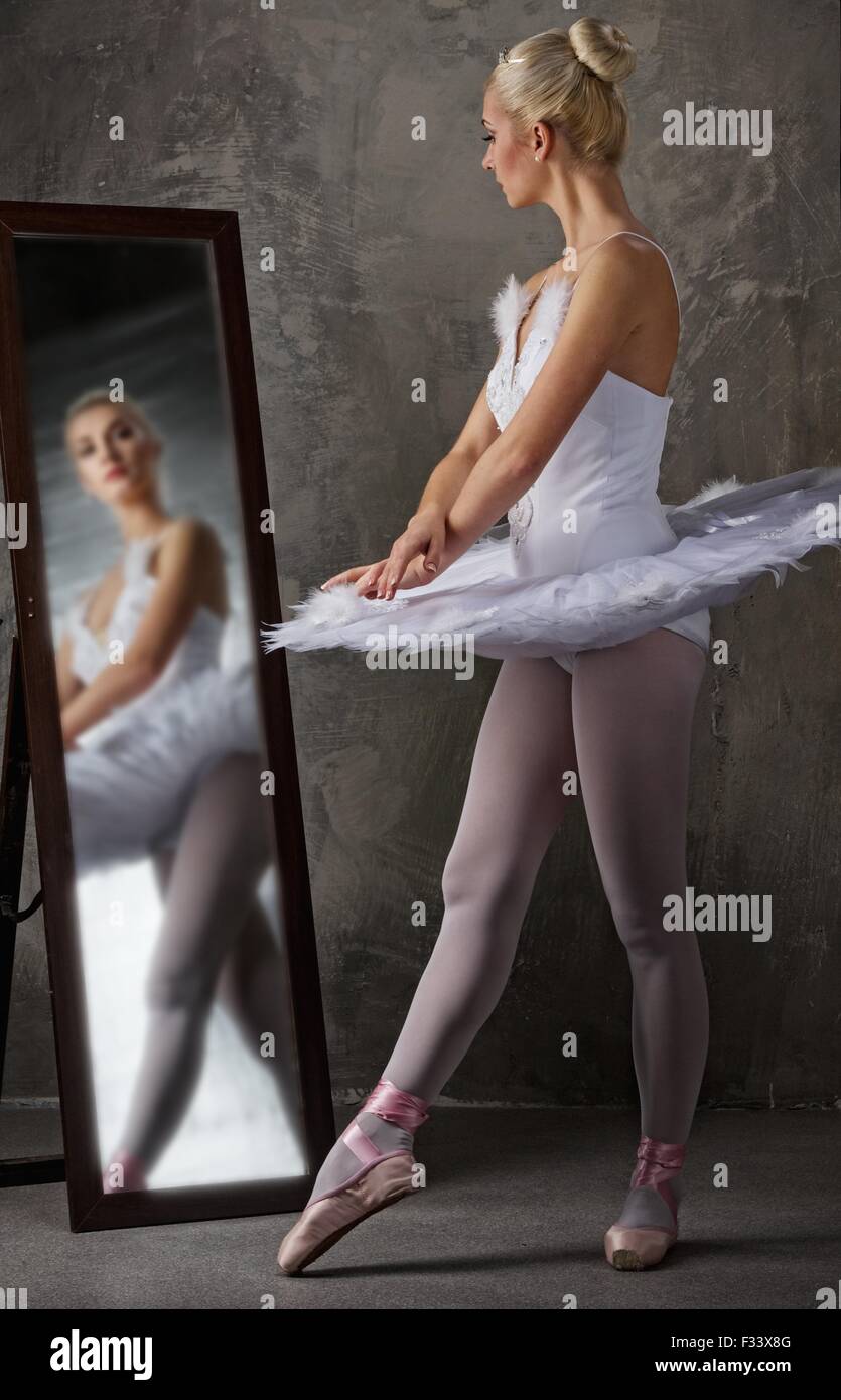 Beautiful ballet dancer near the mirror Stock Photo