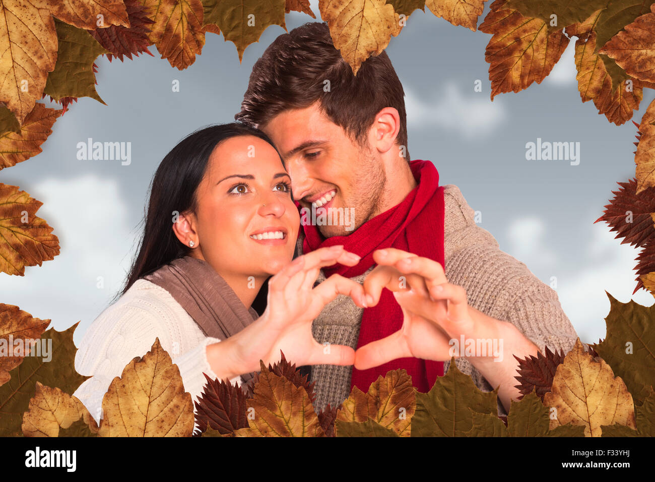 Composite image of young couple making heart with hands Stock Photo - Alamy
