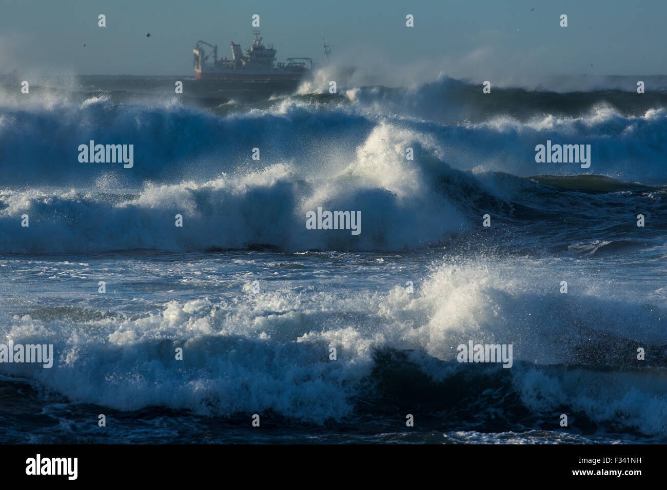 waves breaking around a trawler off the Reykjanes Peninsula, Iceland Stock Photo