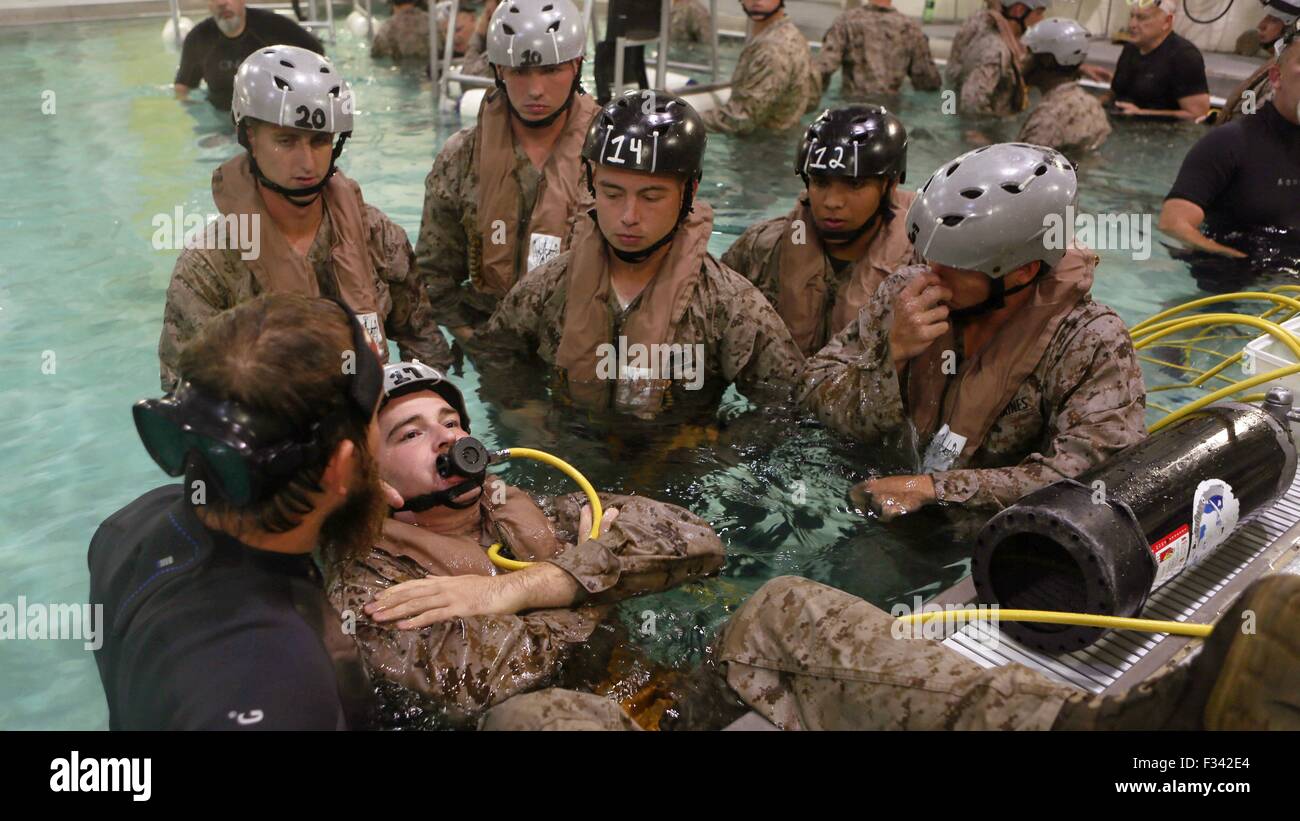 A U.S. Marine prepares to be dunked into the pool wearing a supplemental emergency breathing device during submerged vehicle egress training September 22, 2015 at Camp Lejeune, N.C. Stock Photo