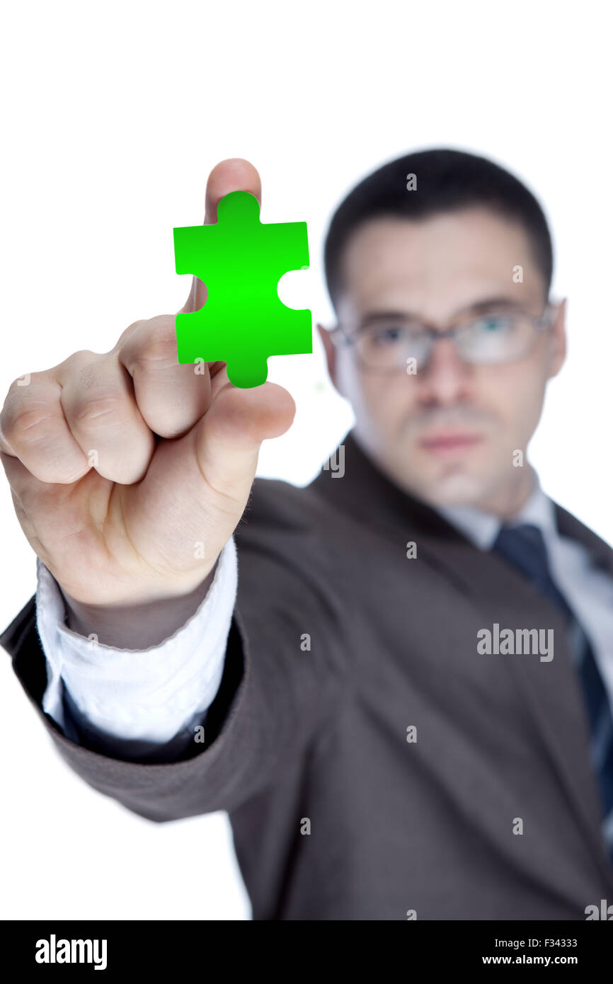 Asian businessman showing a piece of puzzle, over white background Stock Photo