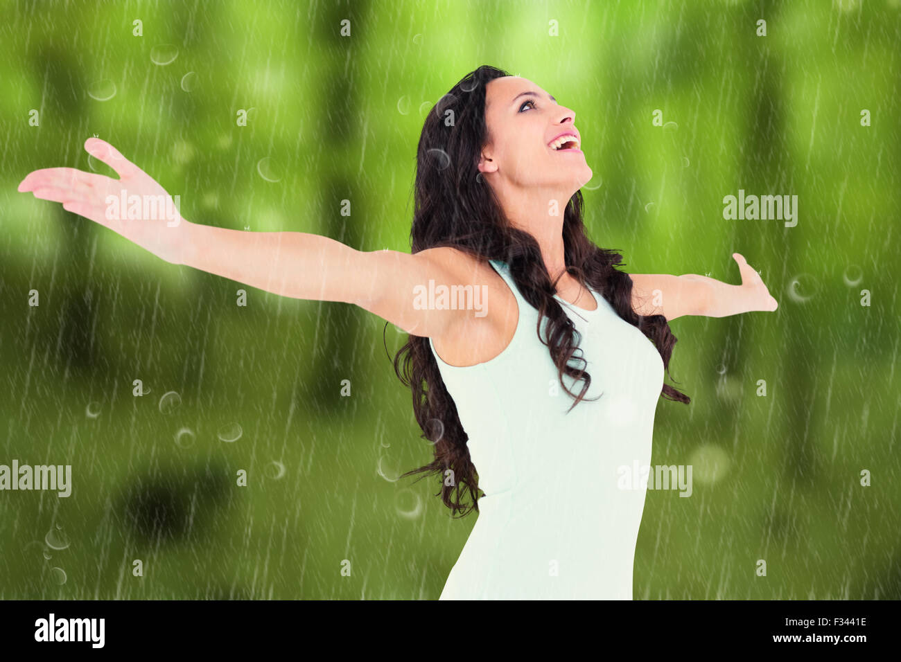 Carefree woman in yellow rain hi-res stock photography and images - Alamy