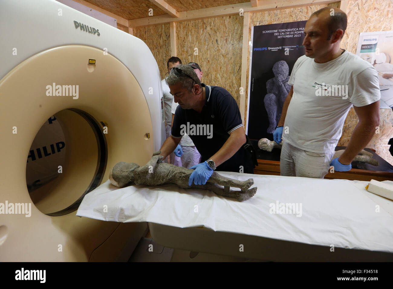 Napoli, Italy. 29th September, 2015. A working team appointed by the Archaeological Superintendence of Pompeii performs a Cat scan (Computerized axial tomography) on one of thirty casts of the victims of the eruption of Vesuvius in 79 AD in Pompeii, in Napoli, Italy, 29 September 2015. Credit:  agnfoto/Alamy Live News Stock Photo