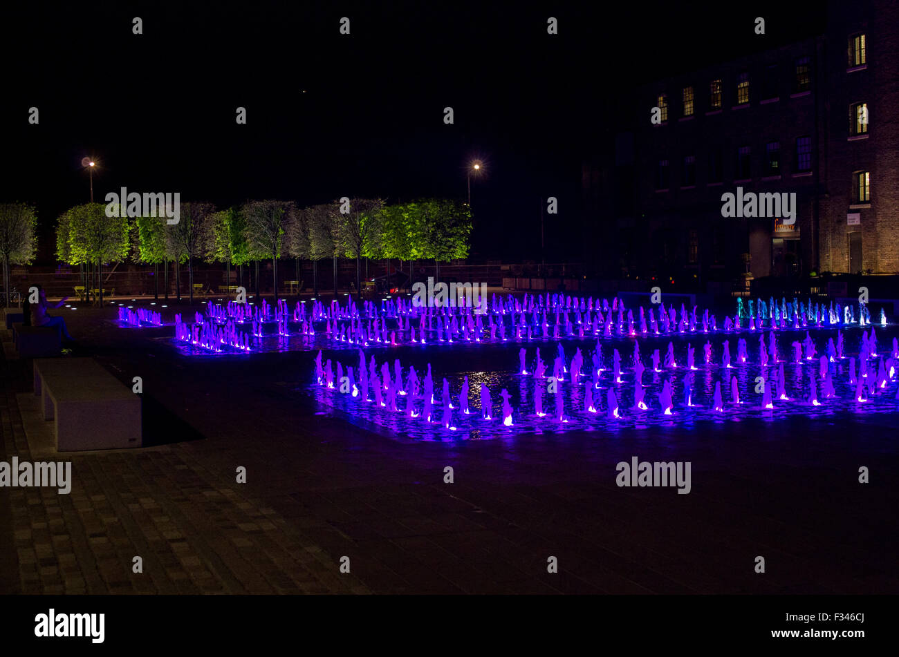 Colourful fountains behind Kings Cross station on Granary Sqare Stock