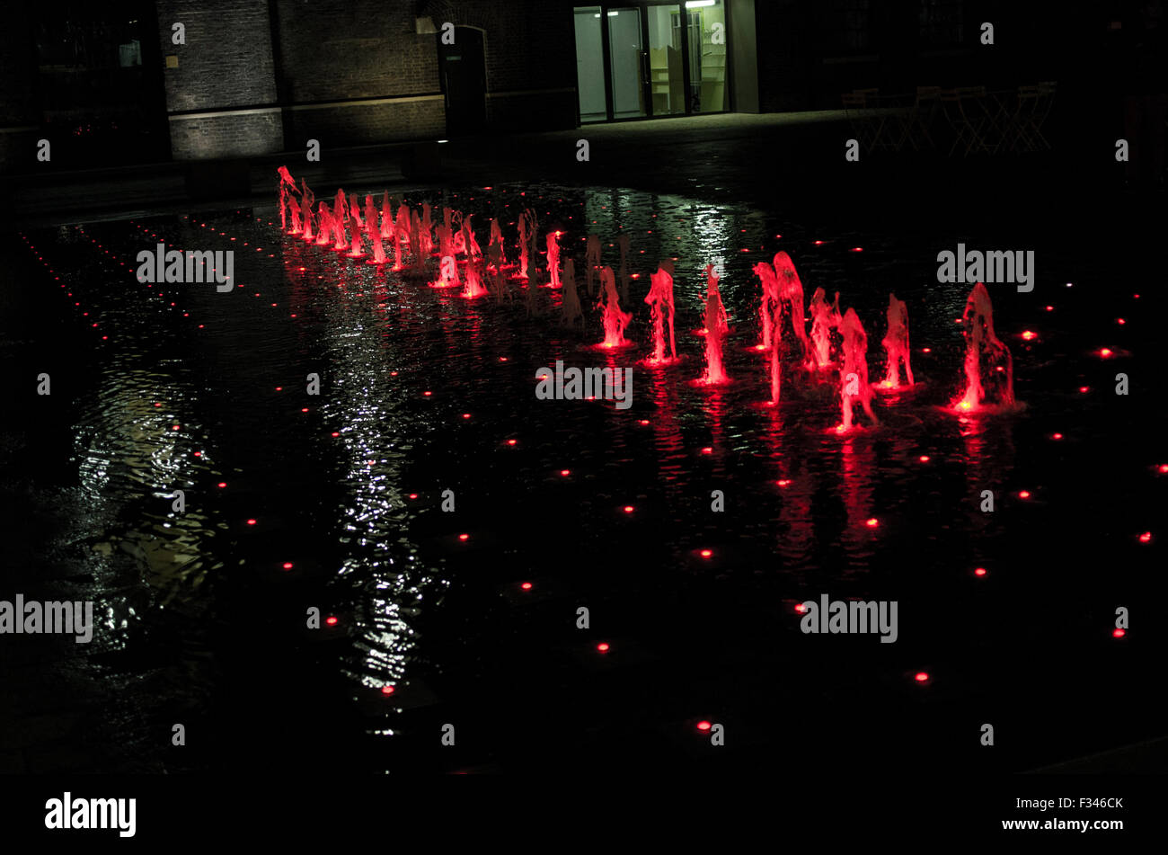 Colourful fountains behind Kings Cross station on Granary Sqare Stock