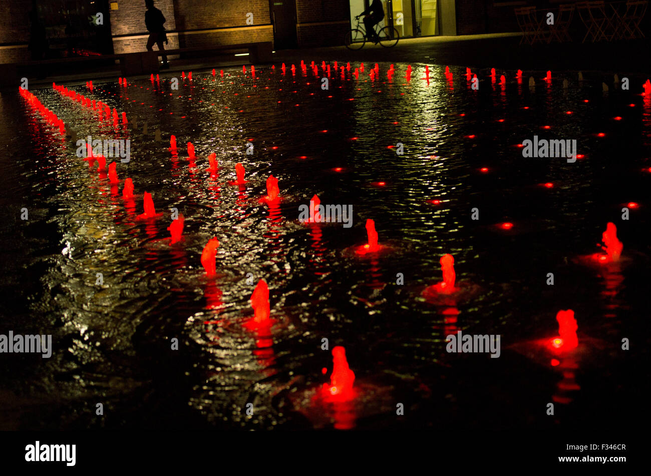 Colourful fountains behind Kings Cross station on Granary Sqare Stock