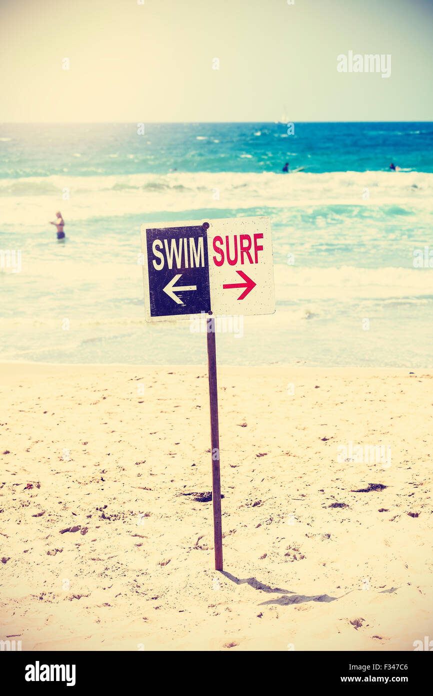 Retro toned swim and surf sign on the beach, shallow depth of field, summer holidays concept, Venice Beach in California, USA. Stock Photo