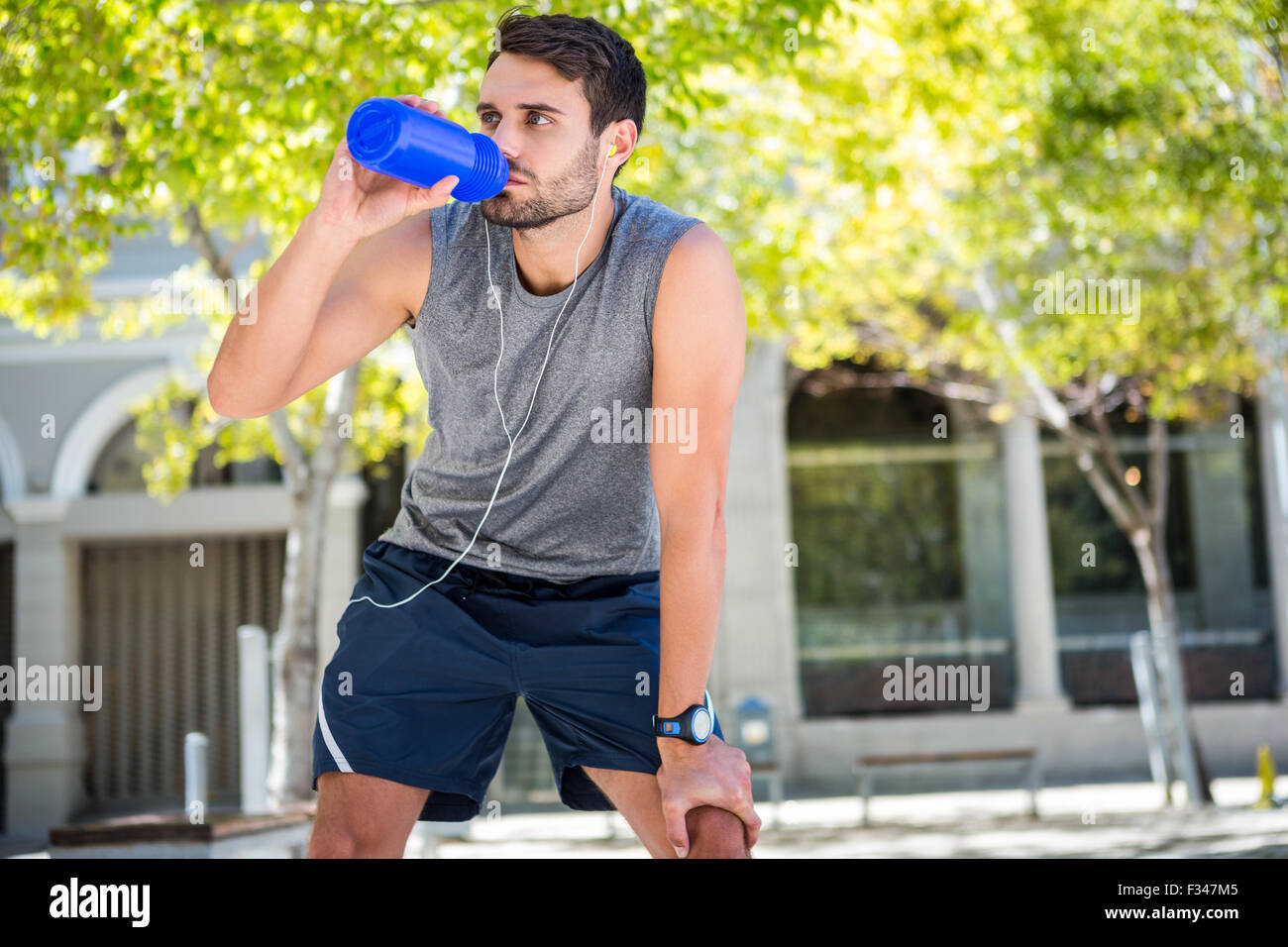 Handsome runner drinking fresh water Stock Photo