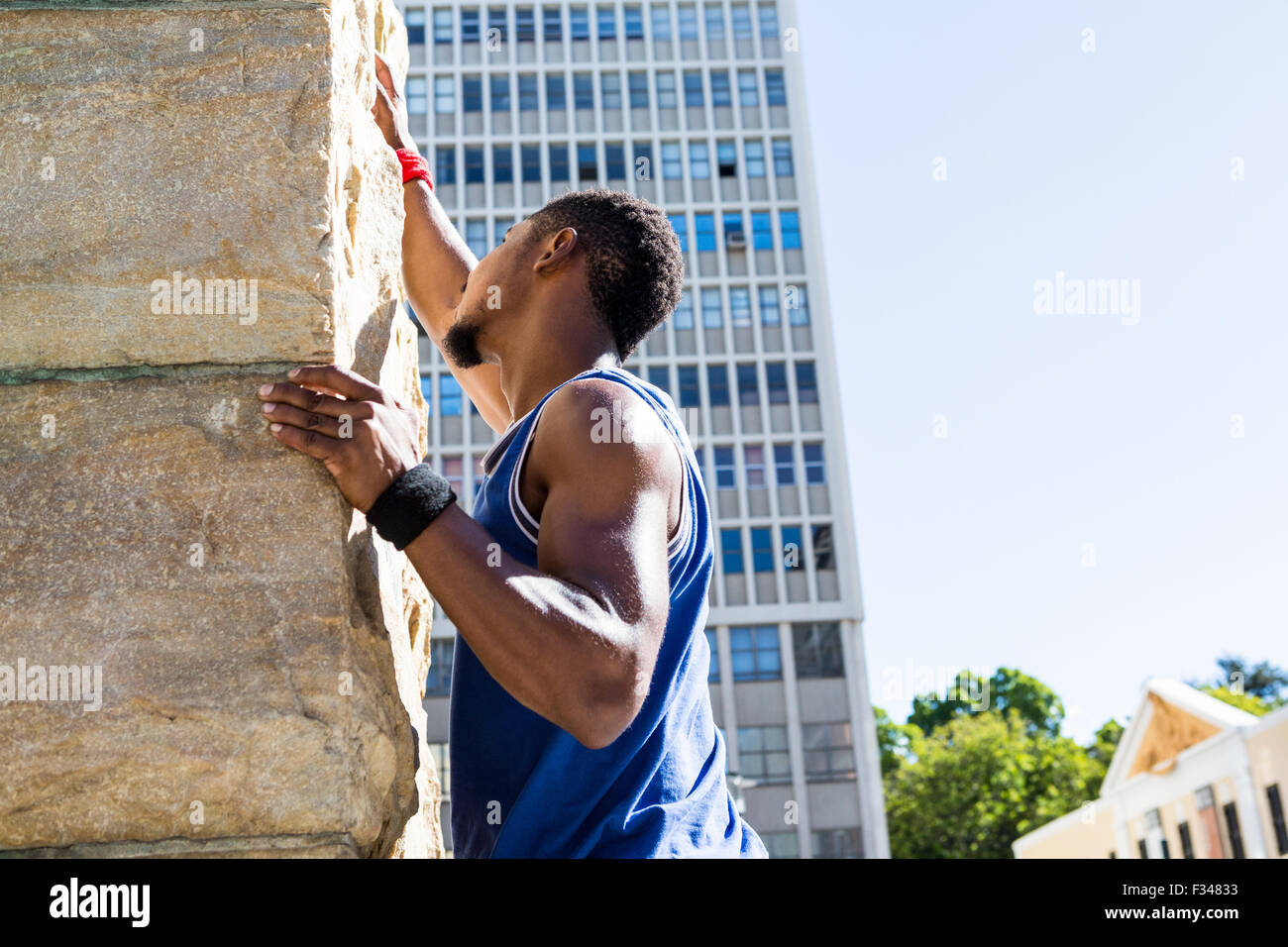 Extreme athlete gripping to wall Stock Photo
