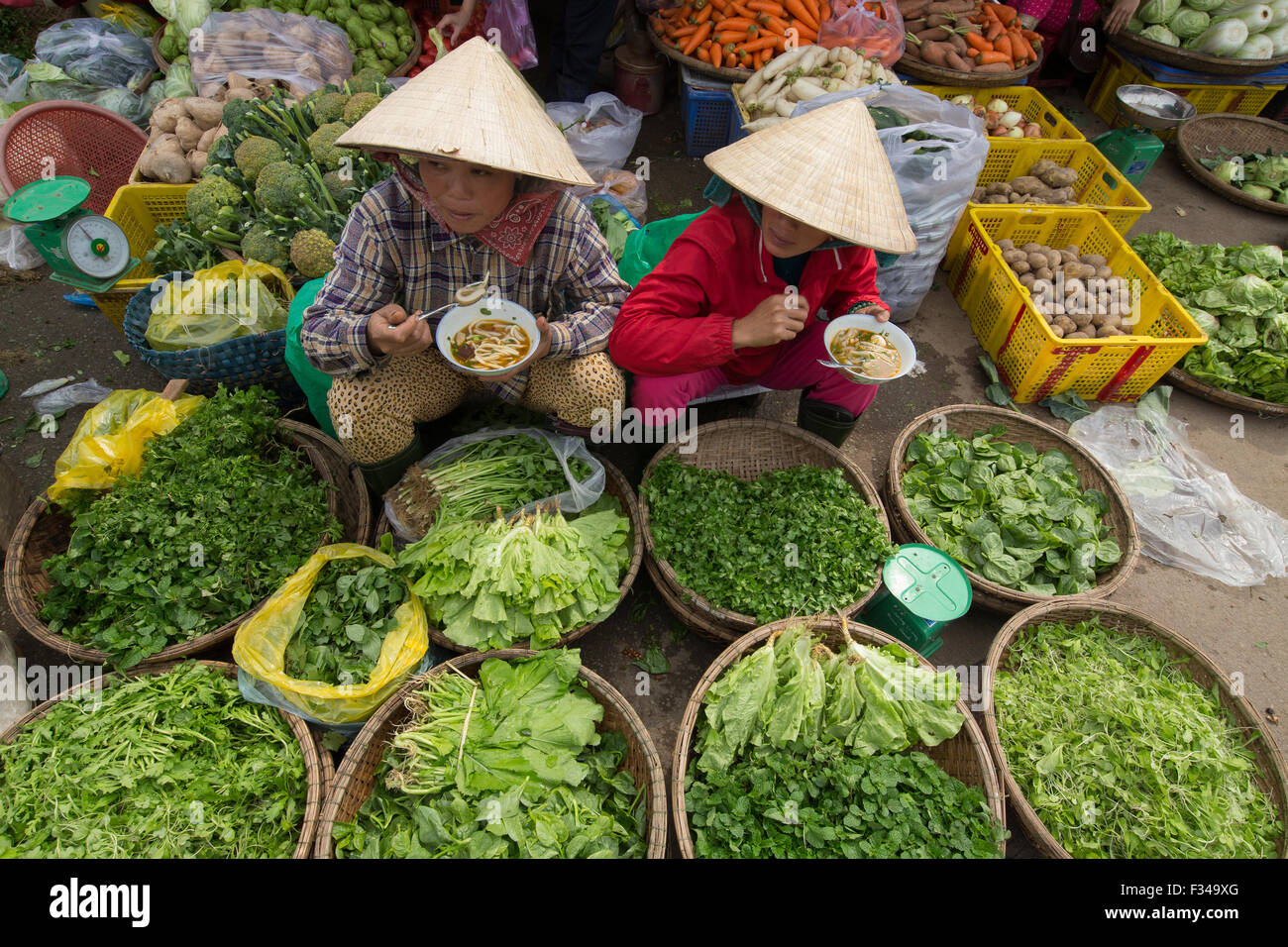 women eating noodles in Dong Ba Market, Hue, Vietnam Stock Photo