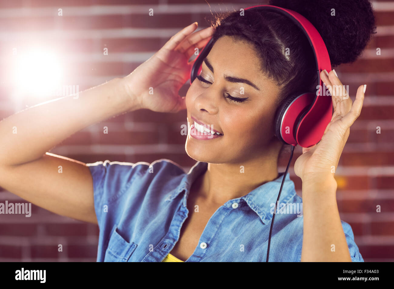 A smiling woman being transported by music Stock Photo
