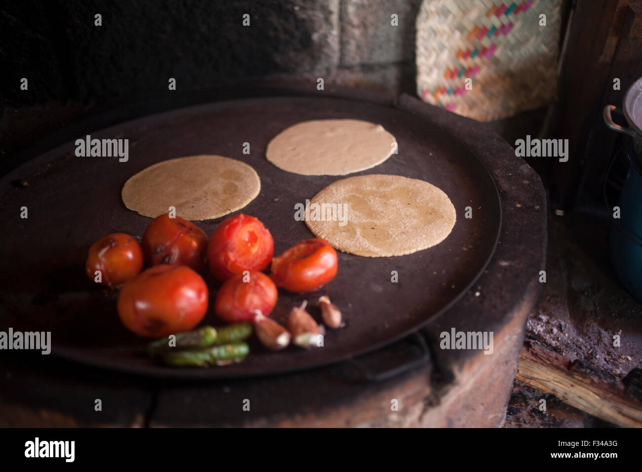 Corn tortillas, tomatoes and green chillies grilled in 'Tepetlixpa Seed Bank', created by Tomas Villanueva Buendia 'Tomaicito' to protect and rescue the original varieties of Mexican corn Stock Photo
