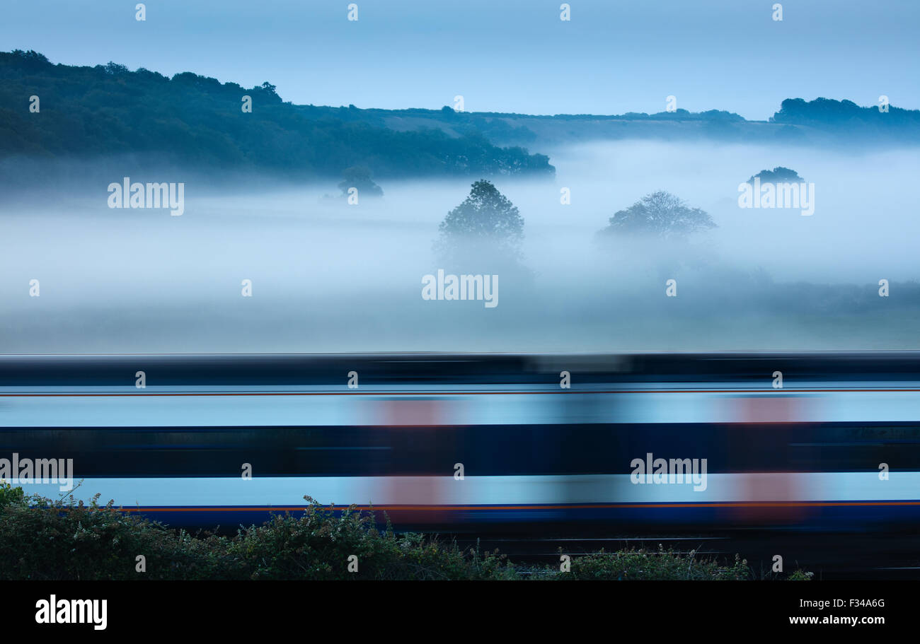 a train passing on a misty morning near Milborne Wick, Somerset, England, UK Stock Photo