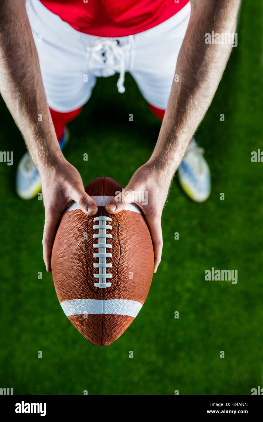 American football player holding up football Stock Photo Alamy