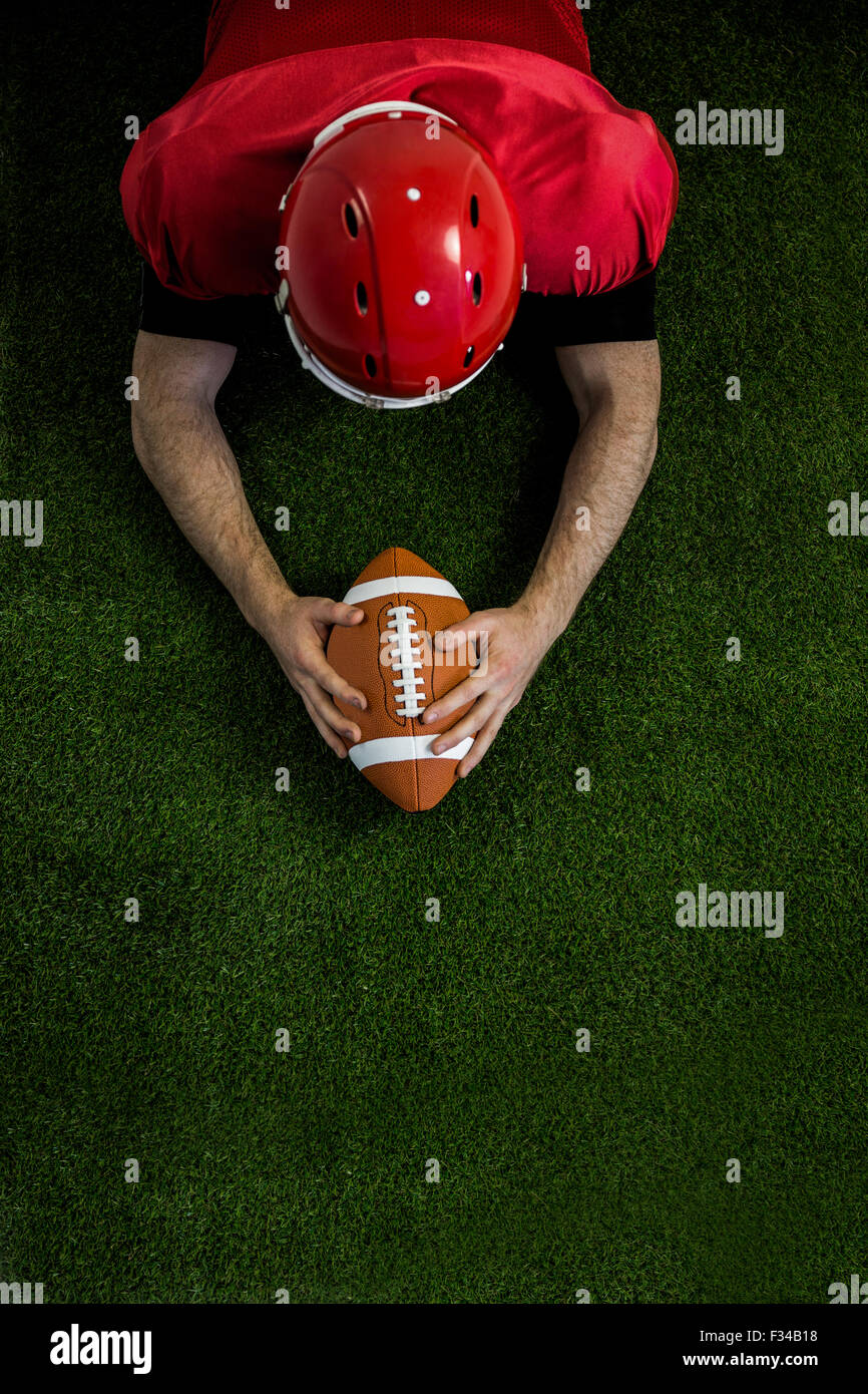 American football player reaching football Stock Photo - Alamy