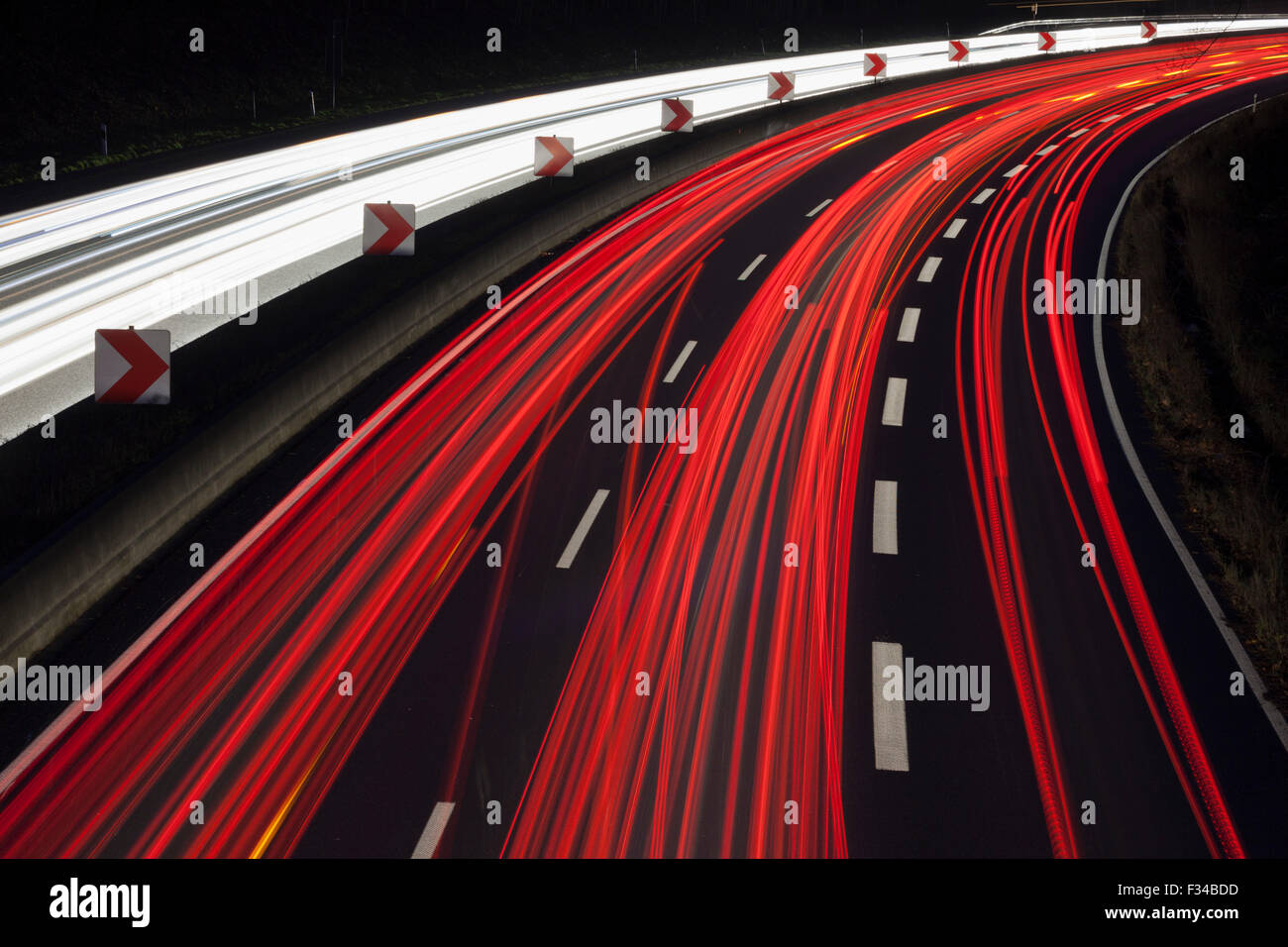 Red and white traffic trails on the German Autobahn, motorway, A40 at Mülheim an der Ruhr Stock Photo