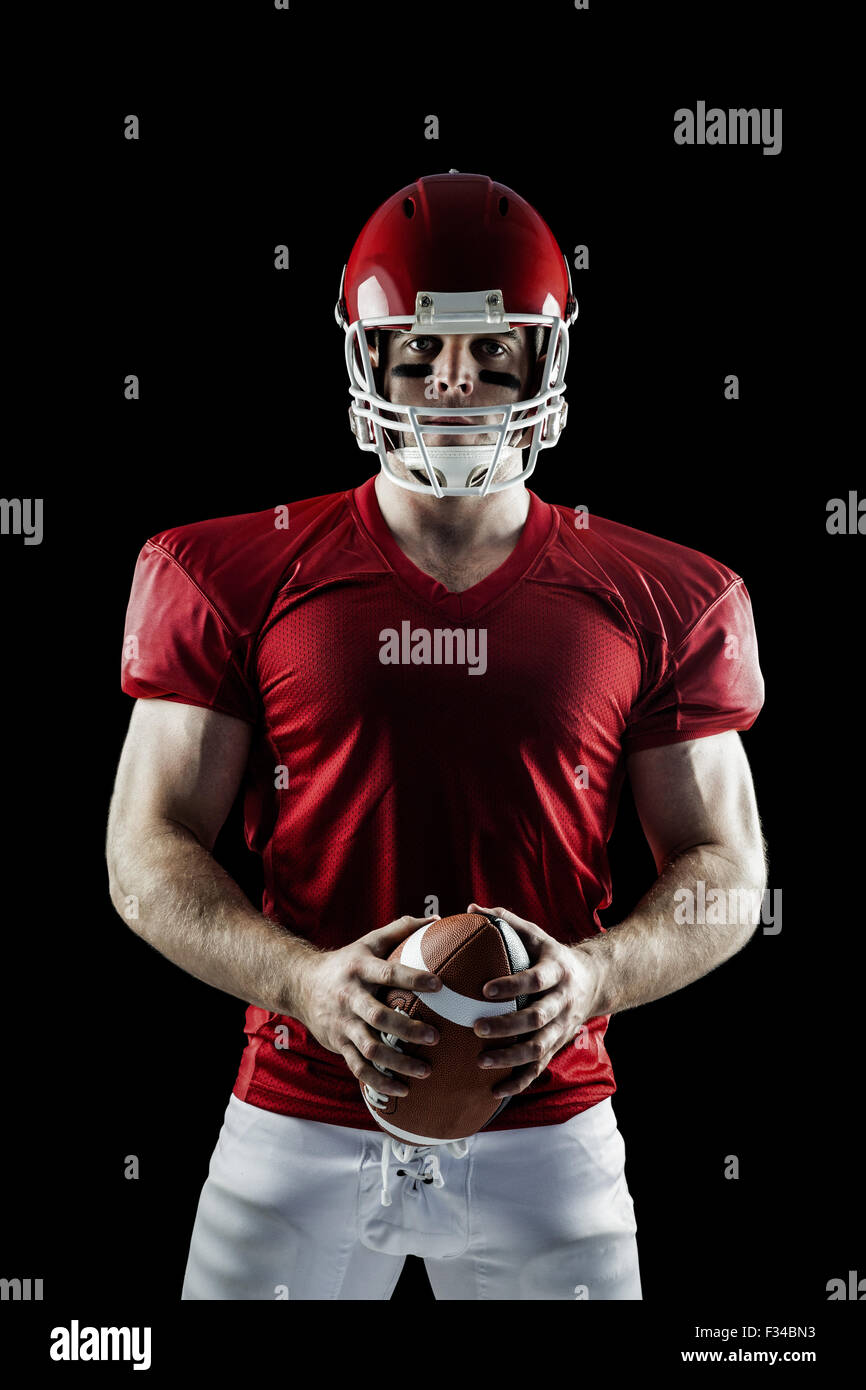 American football player holding ball Stock Photo Alamy