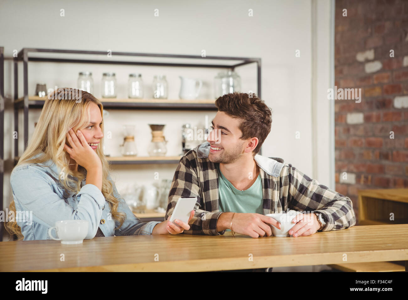 Smiling hipsters sitting and talking Stock Photo