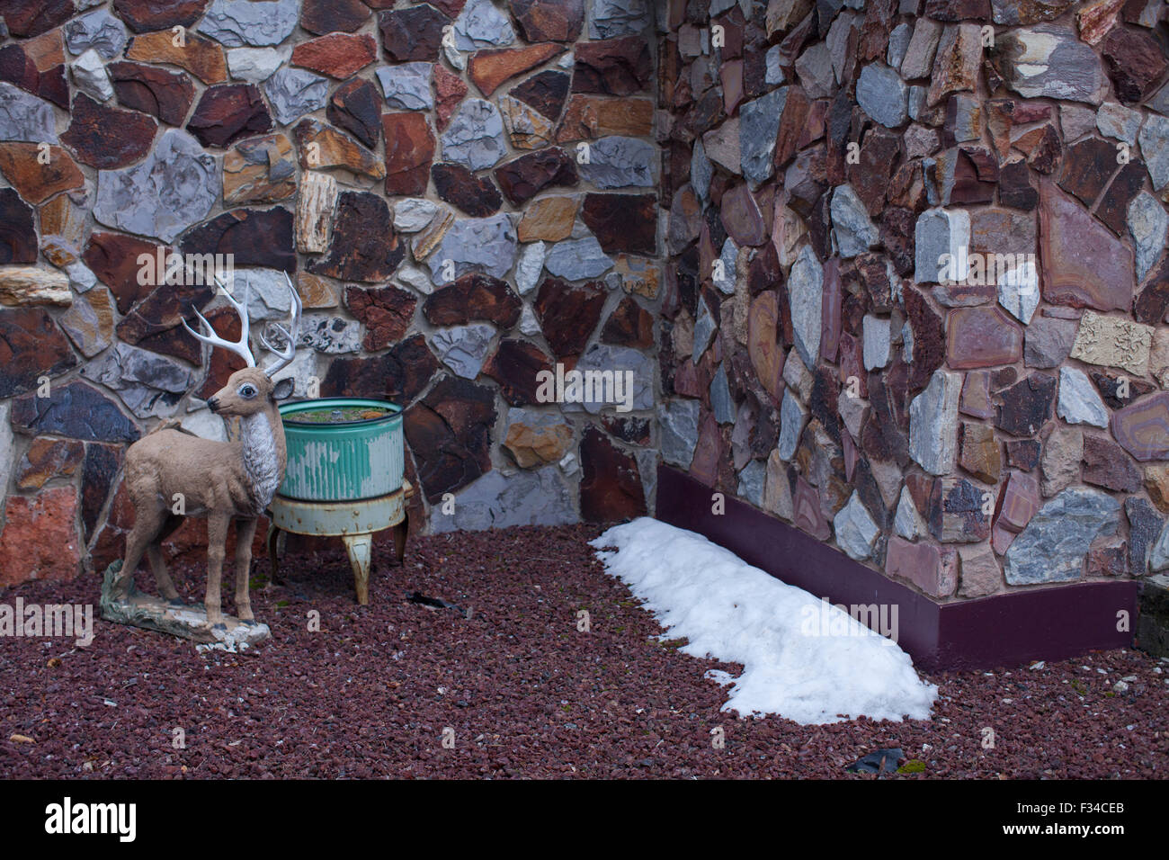 Quirky little scene with a rock wall and a deer. Stock Photo