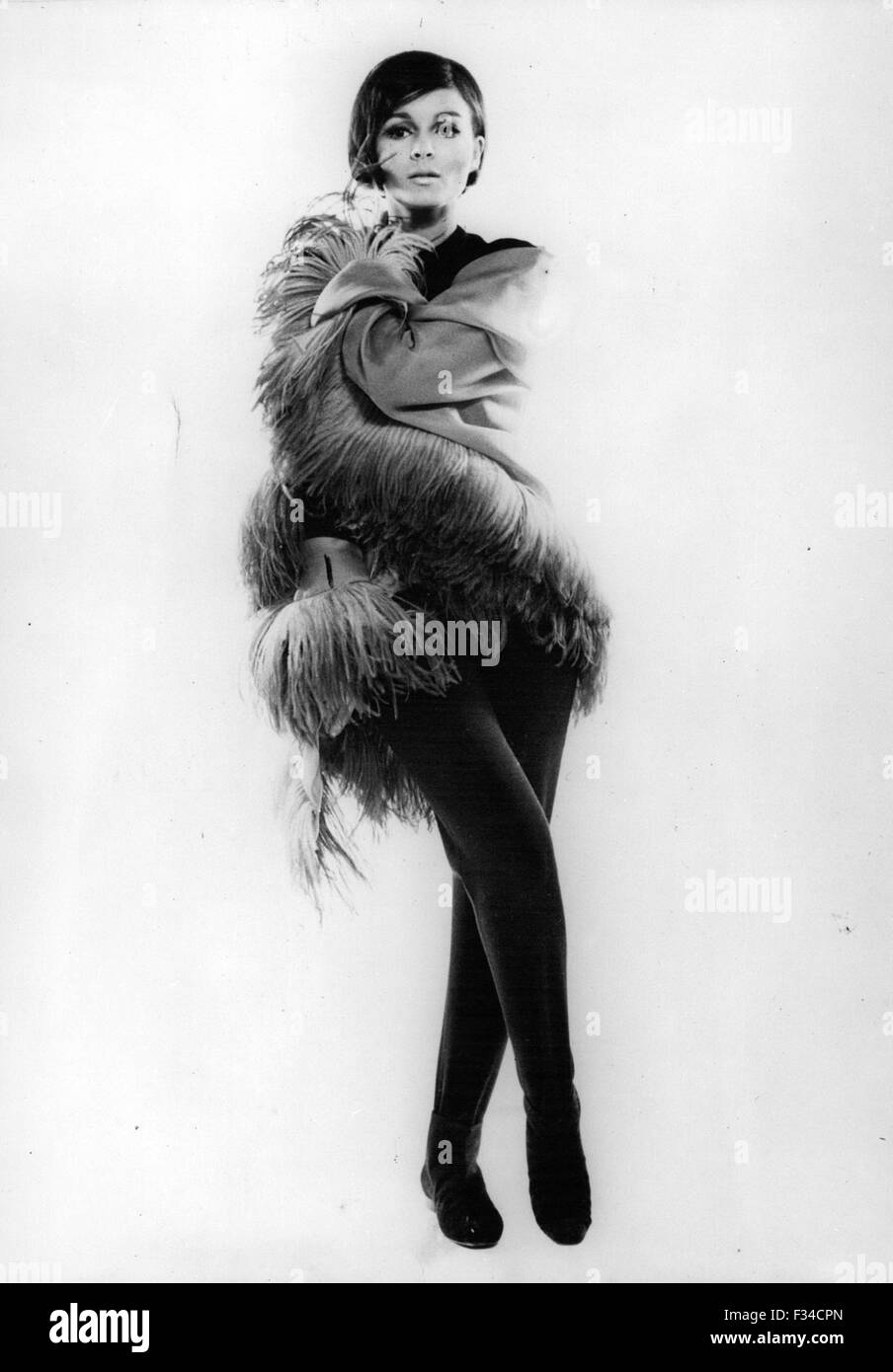 Dec. 20, 1965 - Autumn-Winter Collection 1964/1965 OPS:- 6 A large shawl of turquoise organza luxuriously fringed with turquoise and violst South African ostrich plumes, worn over black jersey tights from Jacques Griffe (mention Obligatory) © Keystone Pictures USA/ZUMAPRESS.com/Alamy Live News Stock Photo