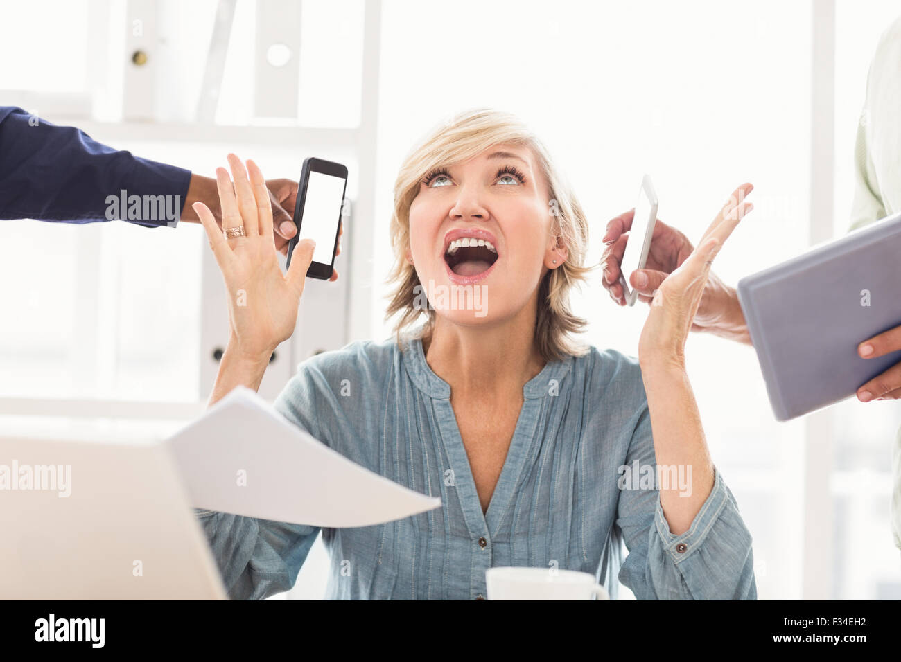 Overwrought businesswoman claiming for help Stock Photo