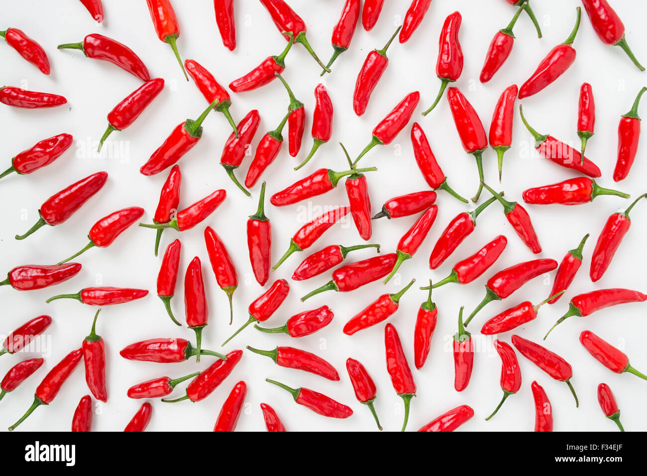 Chili peppers spread out on a white surface Stock Photo - Alamy