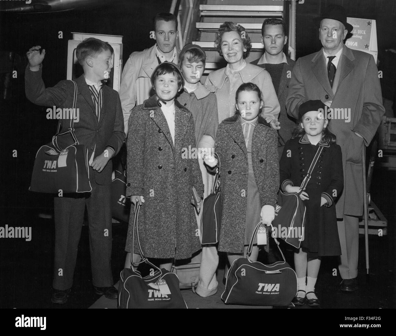 Dec. 26, 1976 - Idlewild Airport New York: Off to Madrid VIA TWA Super G Fly the Farrow Family from Hollywood. Father John Farrow, is famed movie director and he is headed for Spain to start shooting a Warner Bros. Picture on the life of John Paul Jones, The American Naval Hero. Mrs. Farrow is movie actress Maureen O'Sullivan. The seven children are left to right: Front Row: John, Age 11; Prudence, Age 9; Stephanie, Age 3; Therese, Age 6; Left to right back row: Pat, Age 15; Mia, Age 13; Maureen O'Sullivan, Michael, Age 18; and John Farrow Senior. (Credit Image: © Keystone Pictures USA/ZUMAPRE Stock Photo
