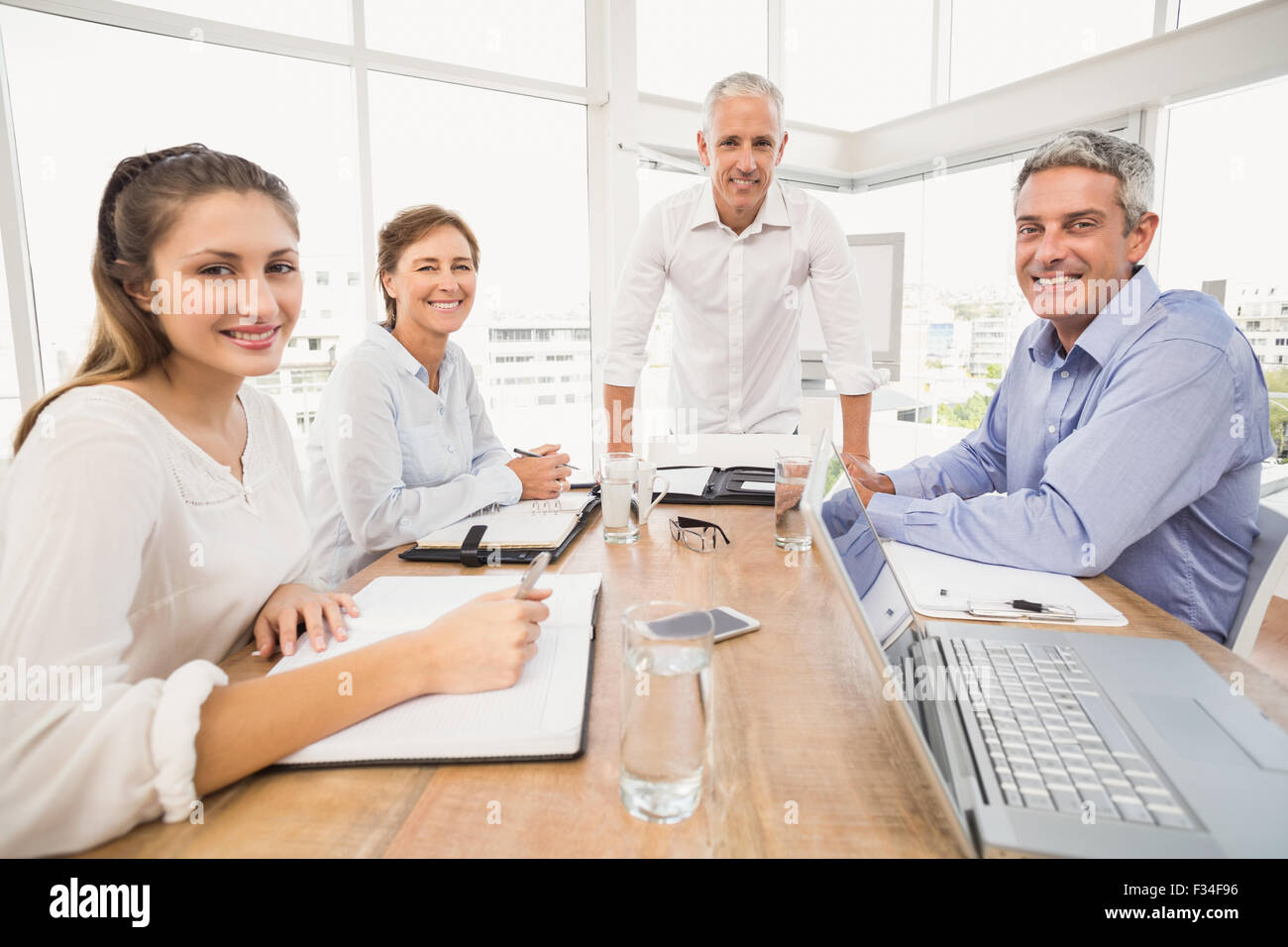 Smiling business people during a presentation Stock Photo - Alamy