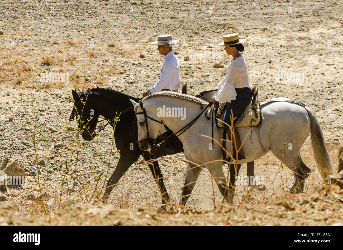 Man and woman on horses, traditional catholic pilgrimage, romeria Virgen del Rosario, Fuengirola, Andalusia, Spain. Stock Photo
