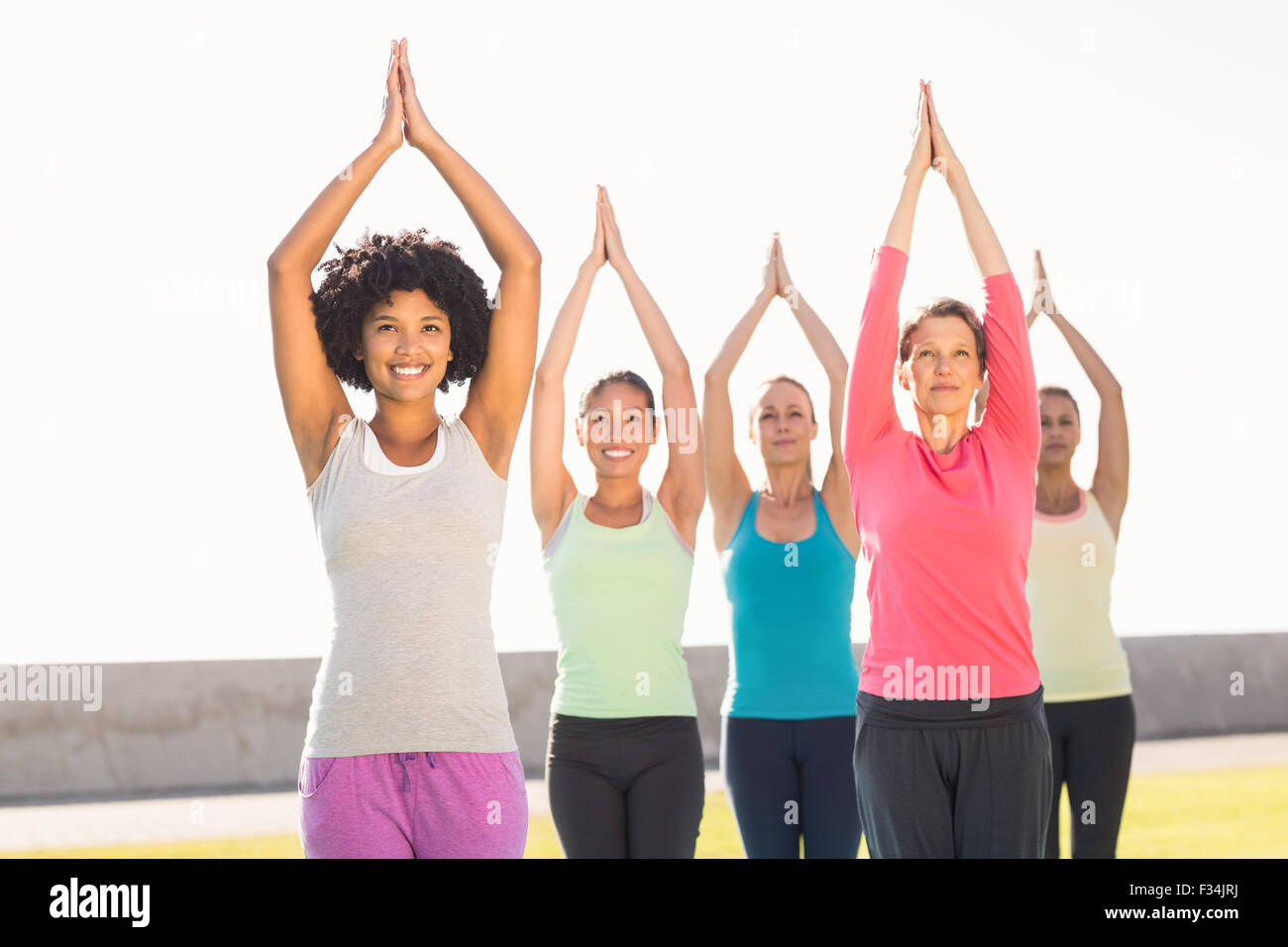 Smiling sporty women doing tree pose in yoga class Stock Photo - Alamy
