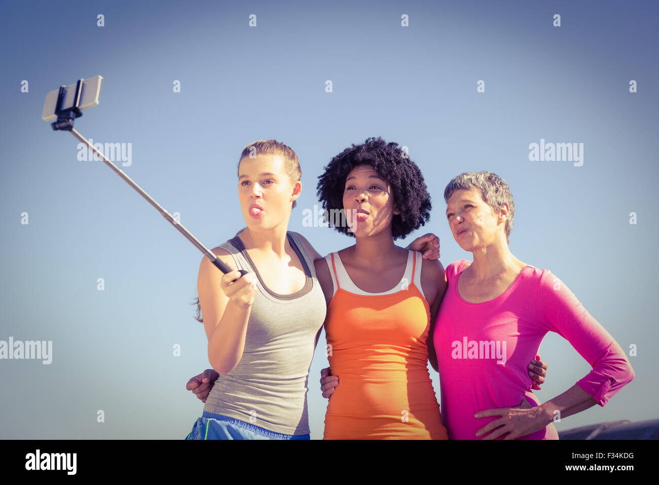 Sporty women posing and taking selfies with selfiestick Stock Photo