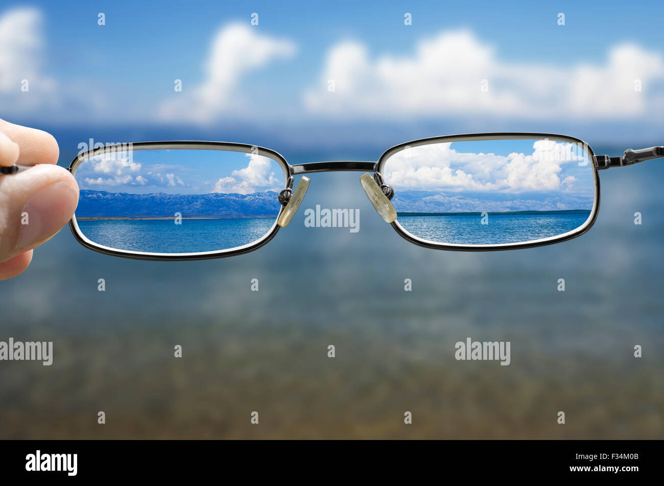 blurry vision of a seashore on a beautiful summer day and a hand